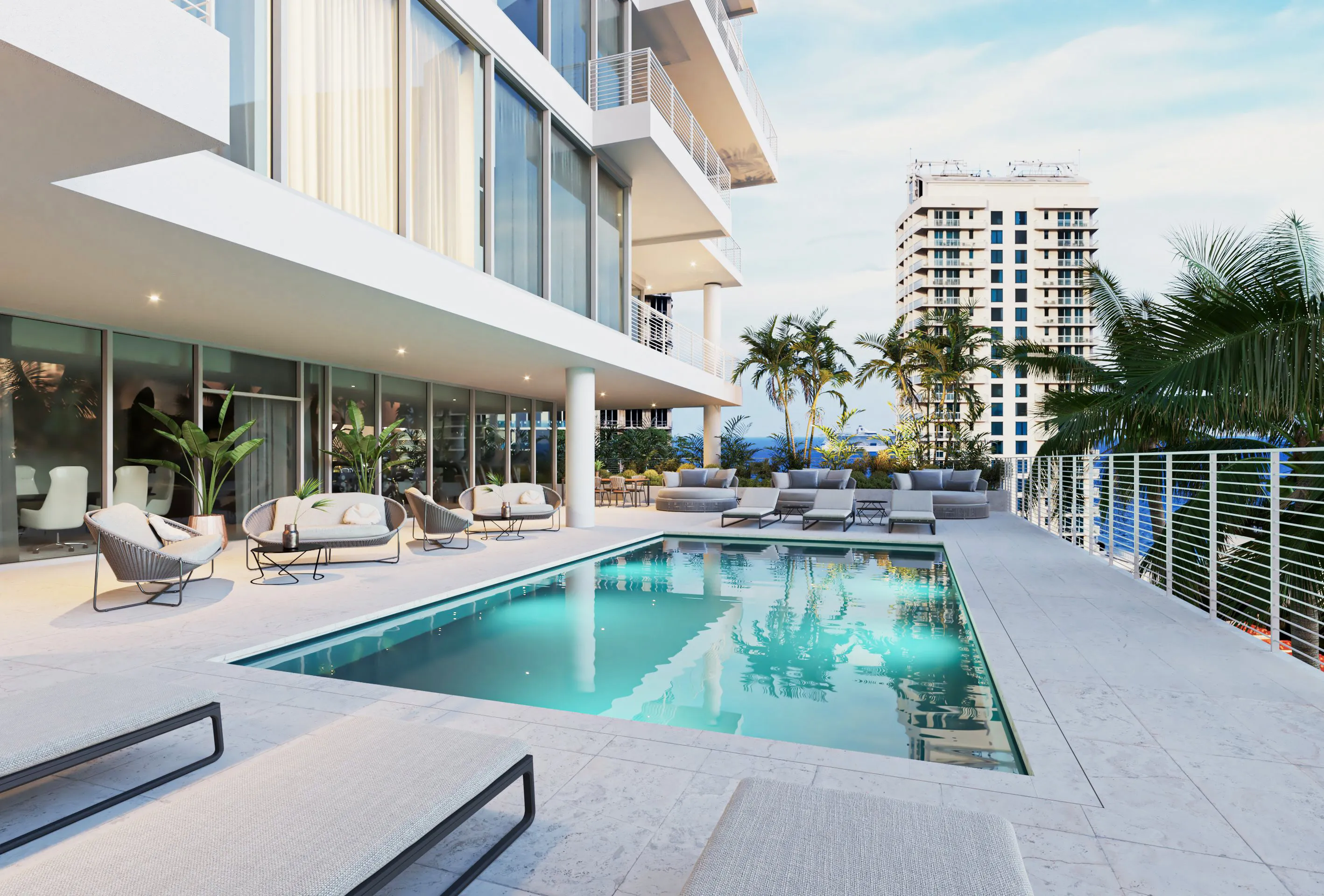 A modern apartment building with a swimming pool in the foreground, showcasing contemporary architecture and outdoor leisure space.
