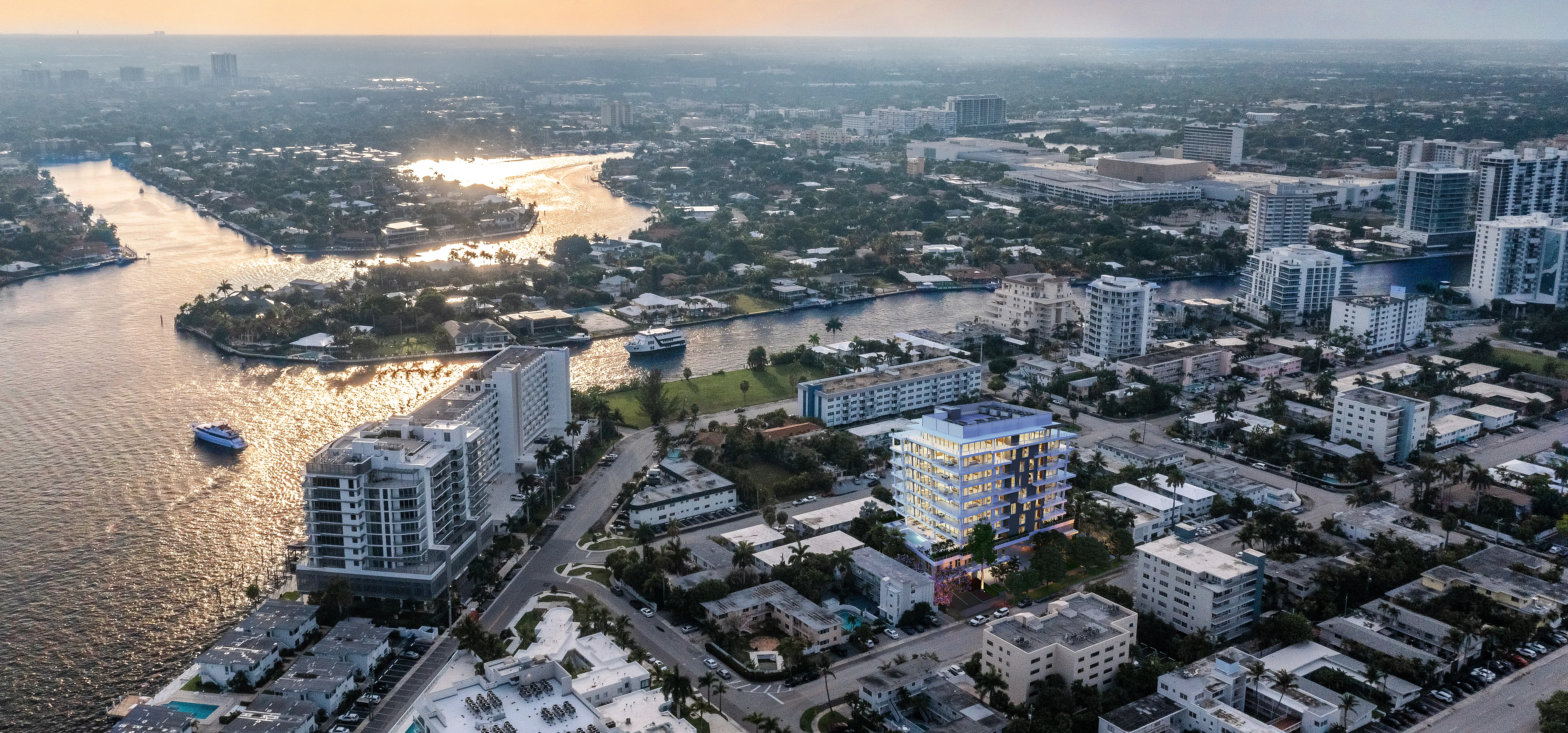 Aerial view of a city featuring tall buildings alongside a winding river.